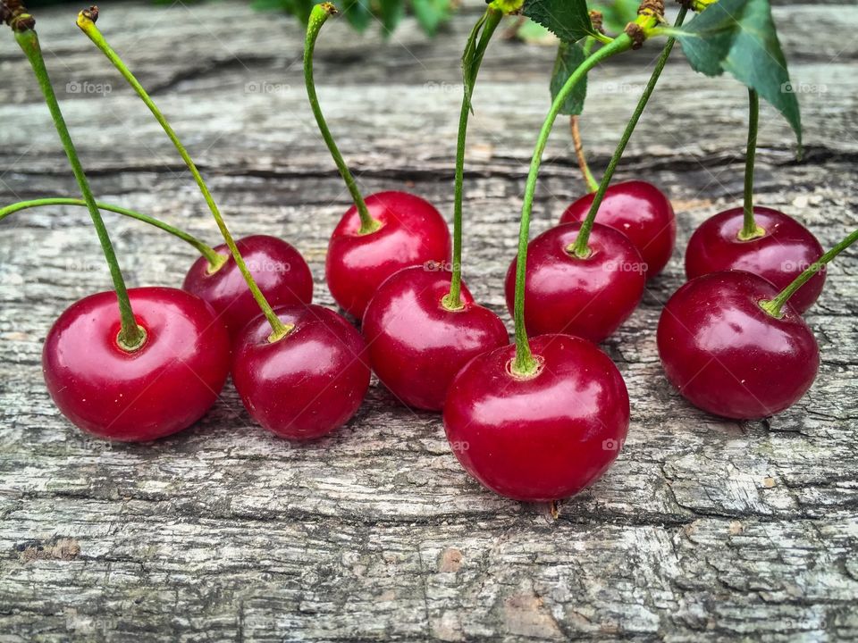 Red cherries on wooden table