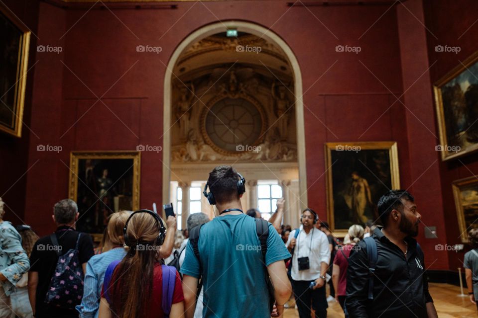 Different people at the amazing Louvre museum in Paris, during summer holiday, escaping from the heat.
