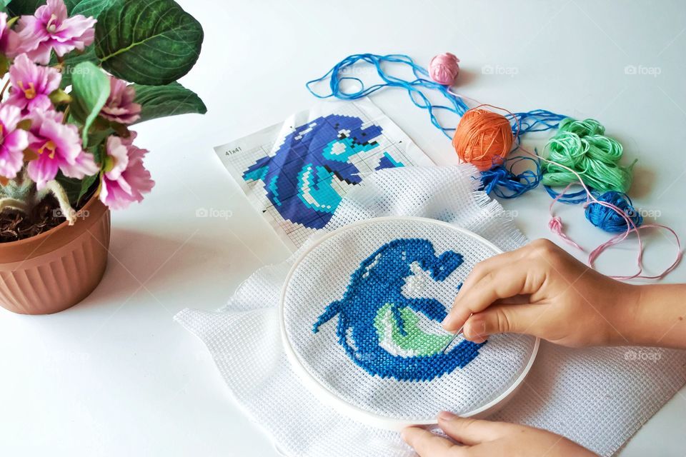cross stitching a dolphin, needlework, hobby, made by hands