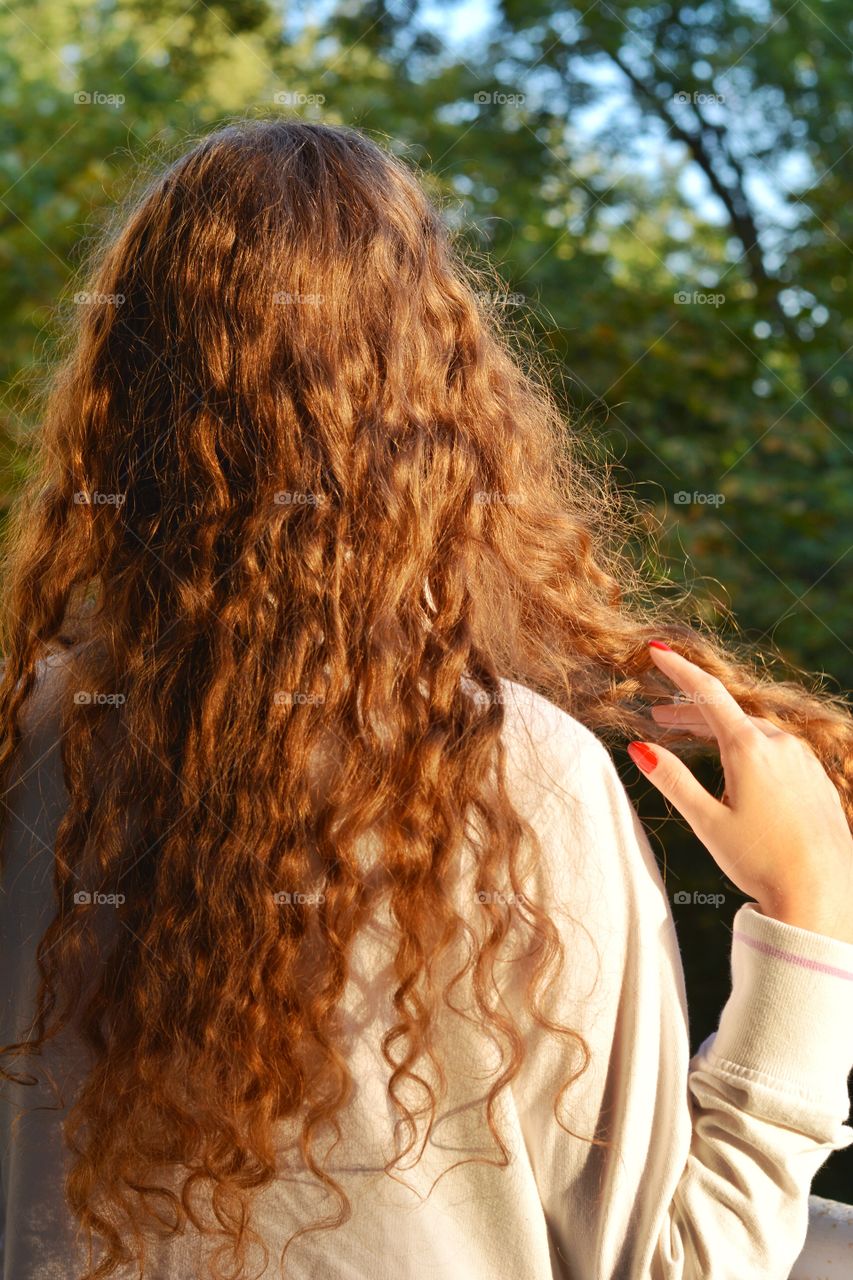 brunette girl hairs in the sunlight outdoor