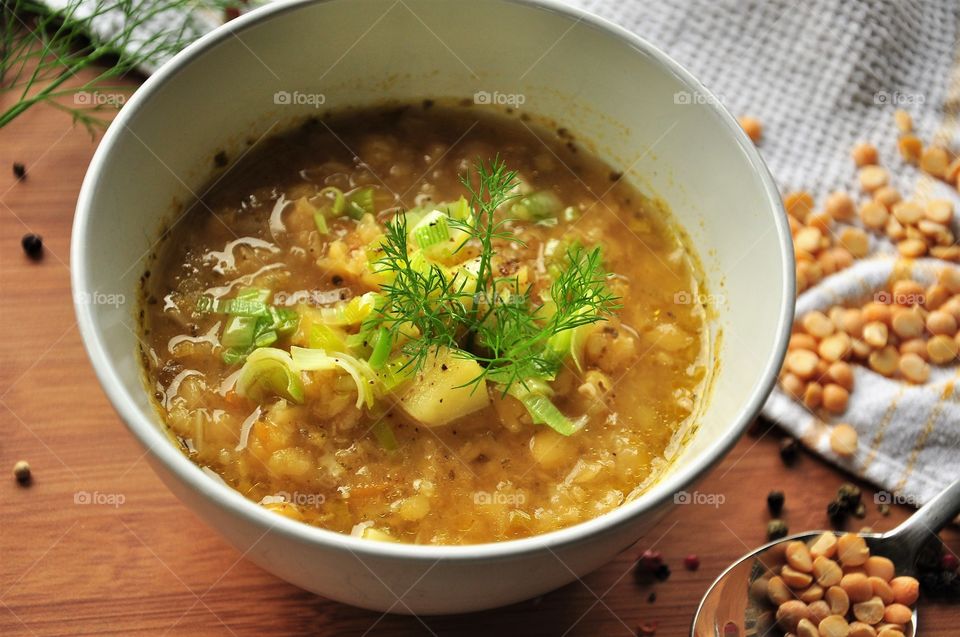 autumn split pea soup with leek potatoes in white bowl