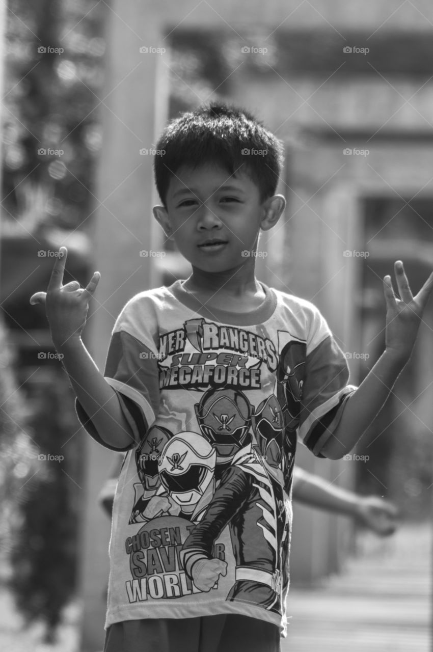 Boy gesturing love hand sign