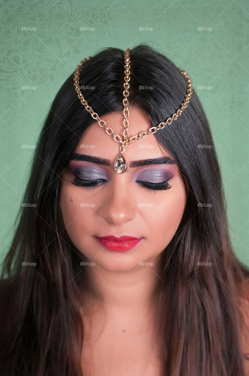 Beautiful face of asian woman with makeup and head jewelry