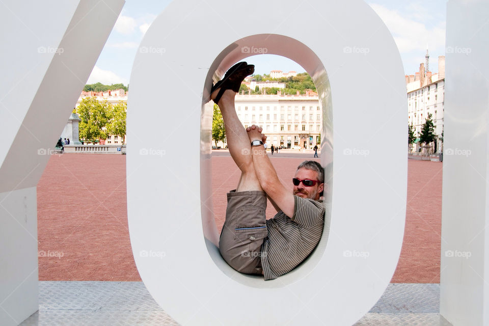 Man posing inside the O in Lyon France