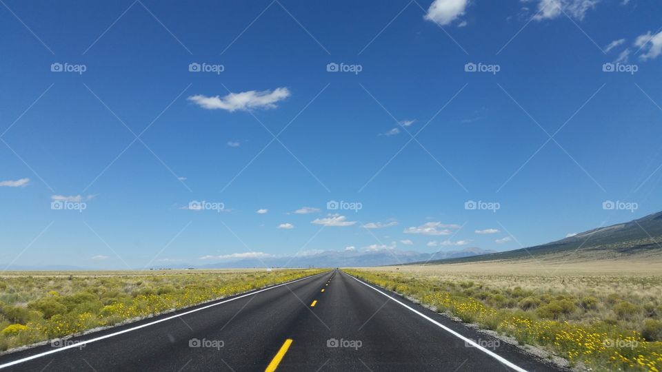 open road under a blue sky