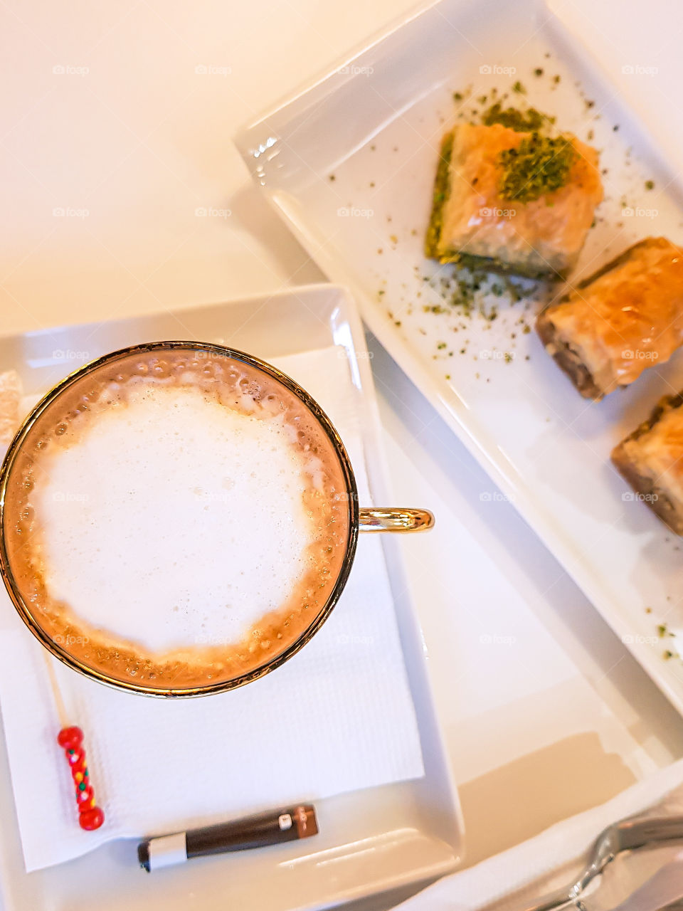 Top view of cappuccino and some traditional sweets.