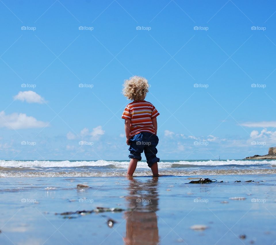 This kid is courageous, he faces the beach as a man not as a child.