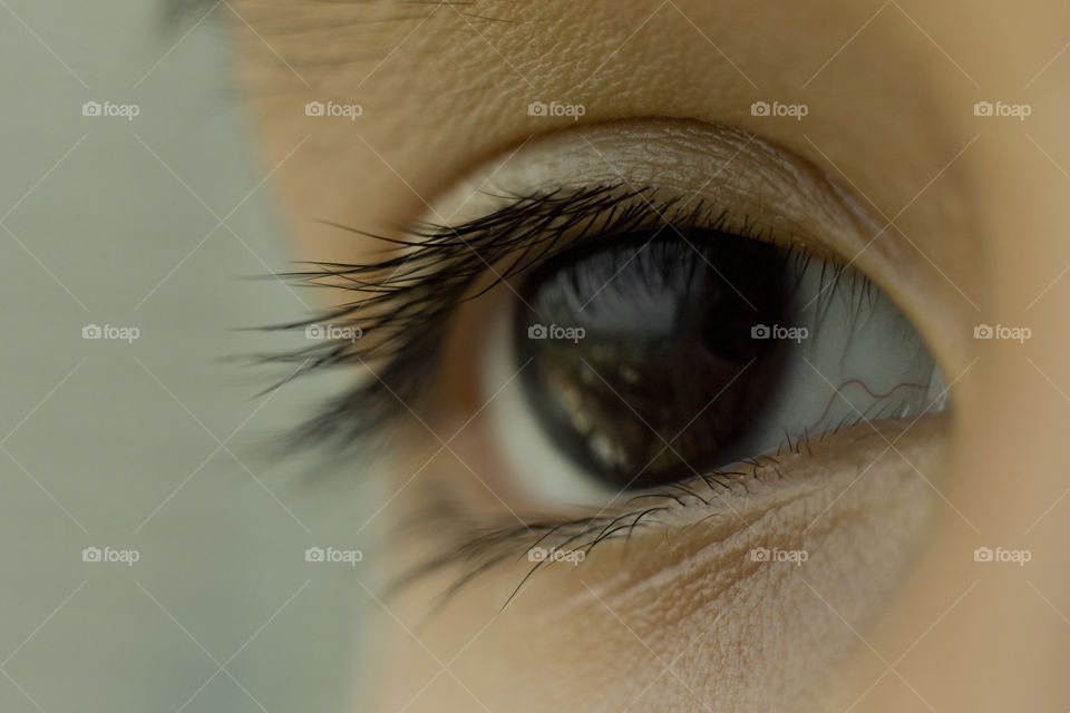 Macro close eyes of Asian kid's. Natural deep dark color iris.