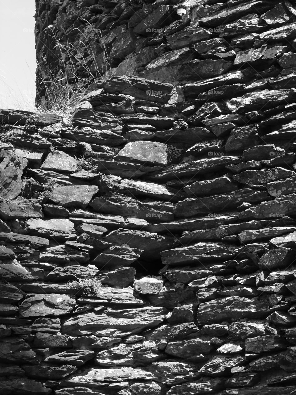 Detailed old historic walls surrounding a fortress in Luxembourg on a sunny summer day. 