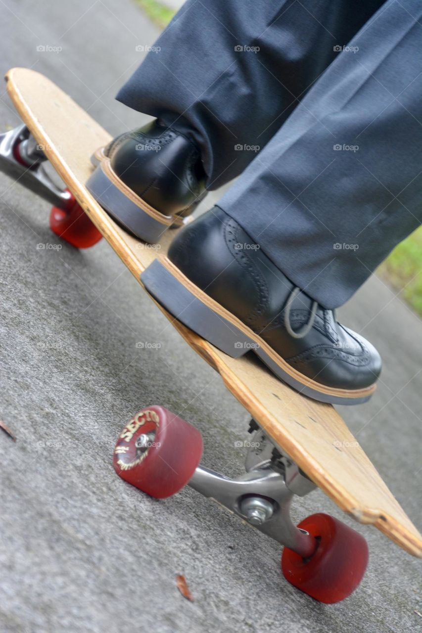 Business man ride, long board ride from ground view