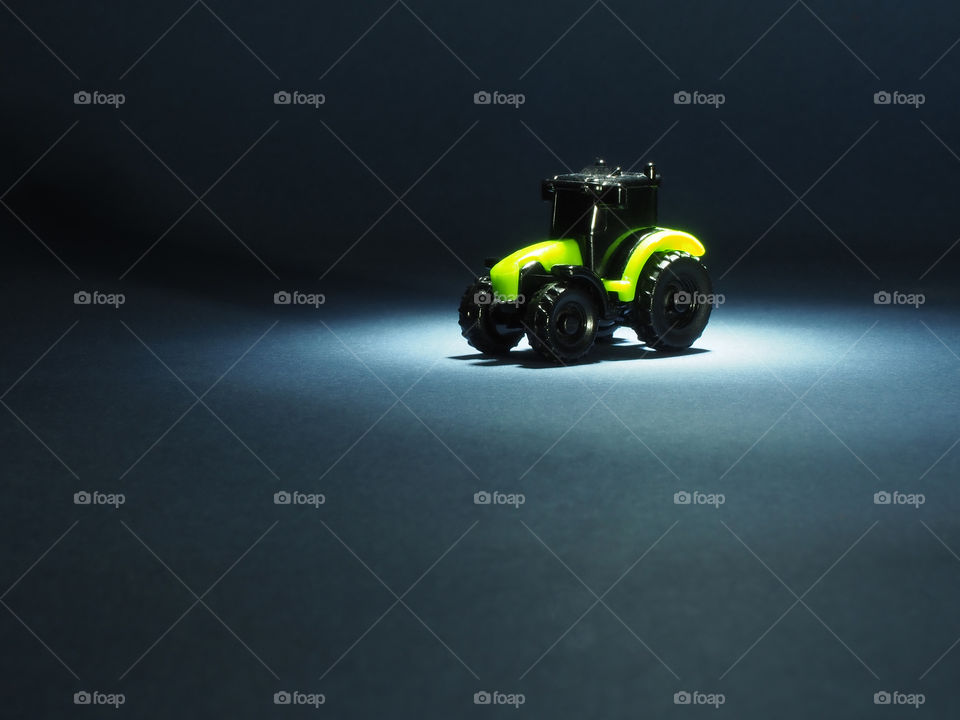 Agricultural machinery Tractor black and green on a dark background.