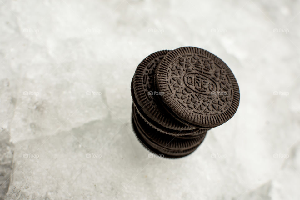 Pile of Oreo Cookies artistic shot on arctic terrain with broken ice pieces and ice covered snow plies of fun Oreo winter background thin and thick Oreo Cookie art photography 