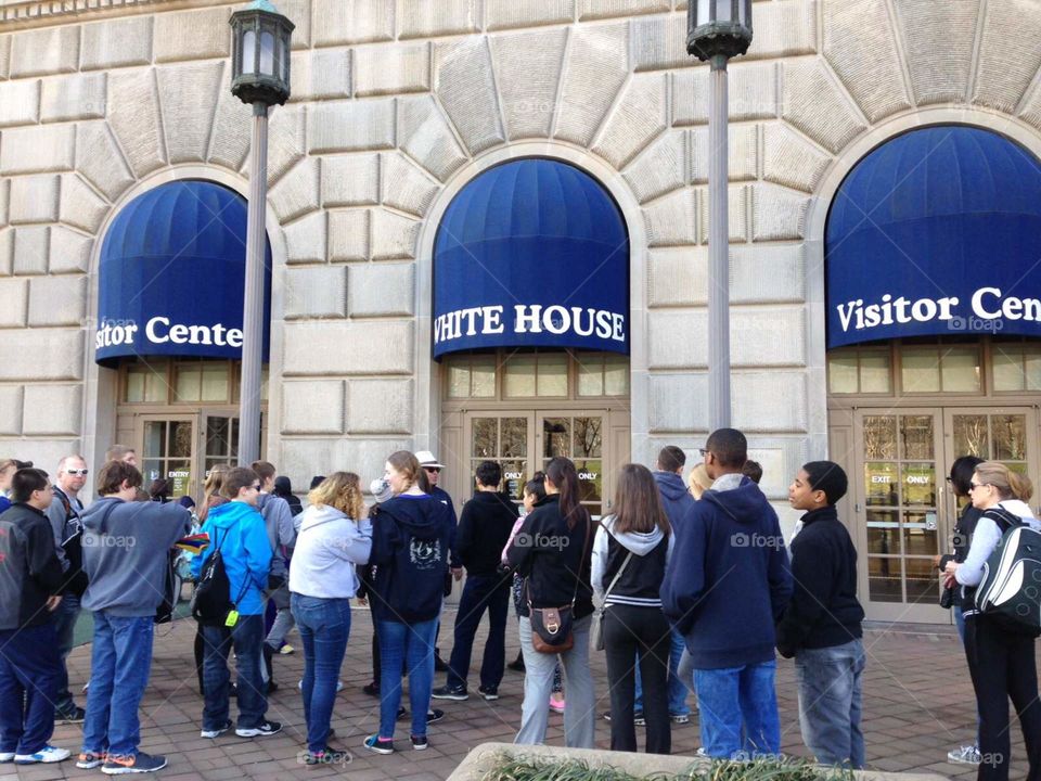 People standing in line outside the White House visitors center.