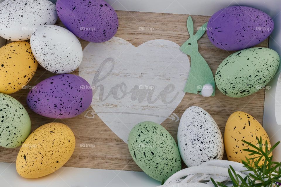 Colourful eggs on a tray that says home 