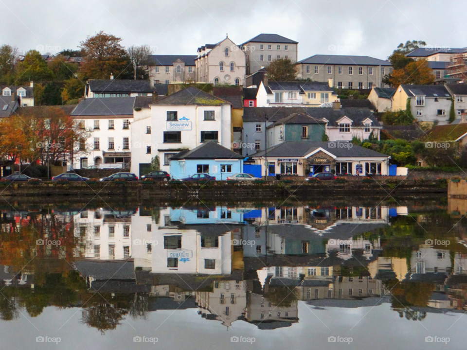 Reflection of houses on estuary in Ireland
