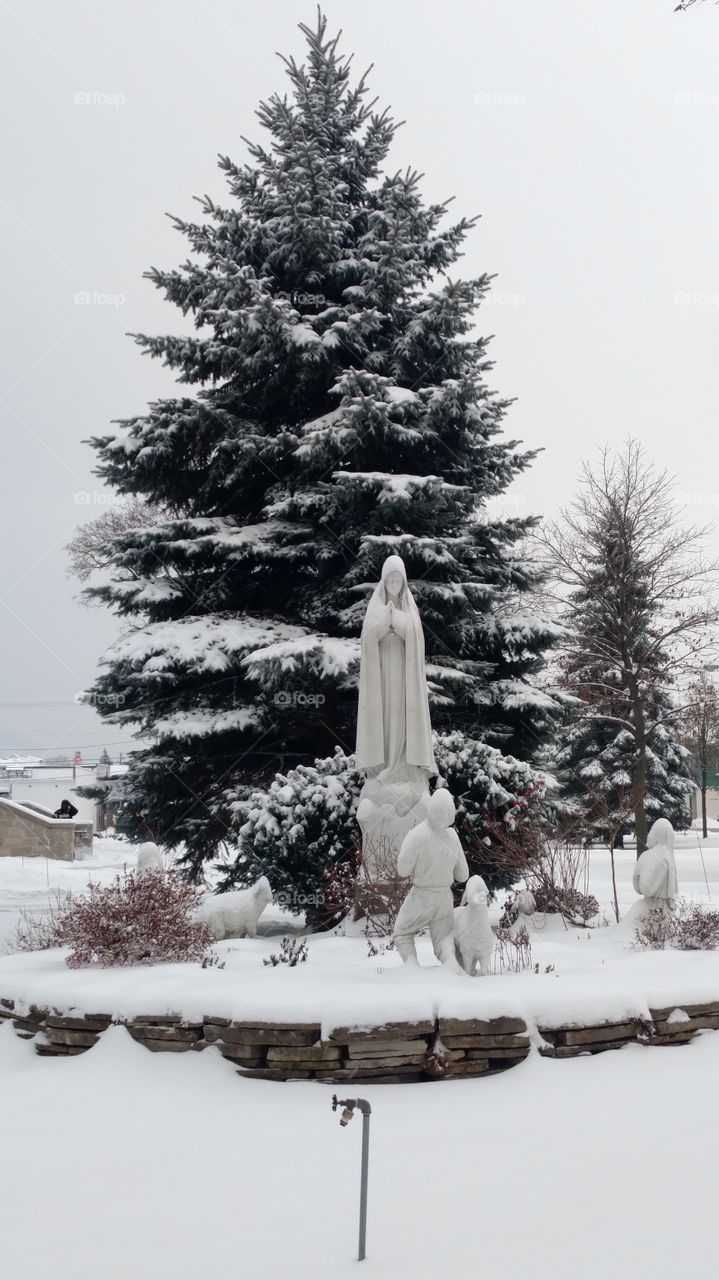 Catholic statue in the snow