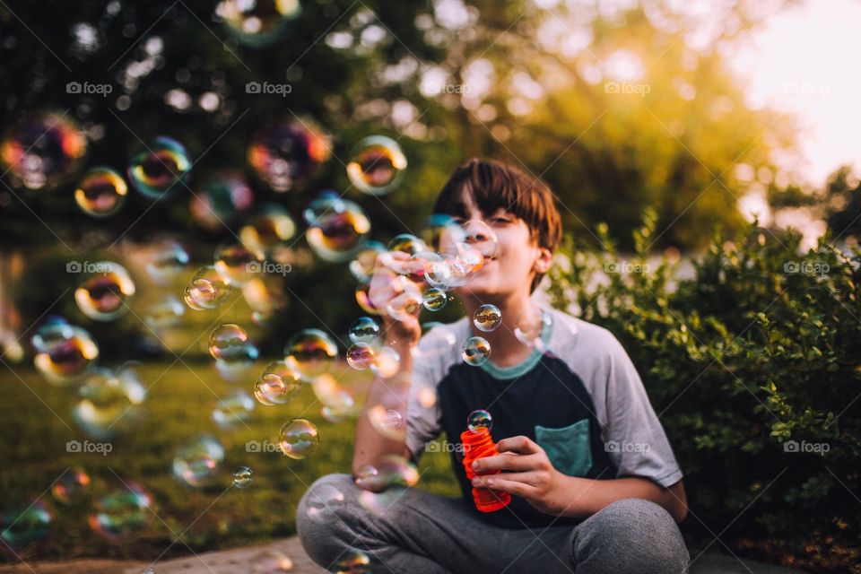 Boy blowing bubbles