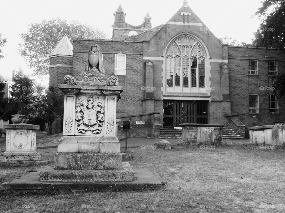 An old church with headstones in the yard in England. 