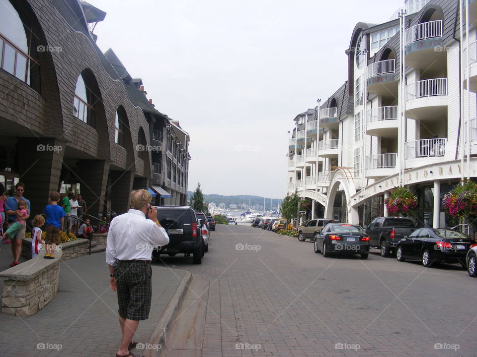 Street in a town next to Lake Michigan with large buildings, condos