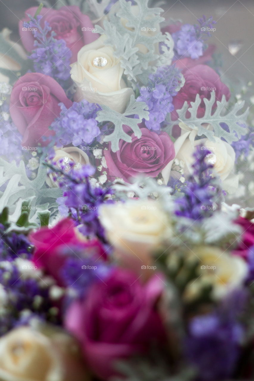 Floral wedding bouquet reflected in a window