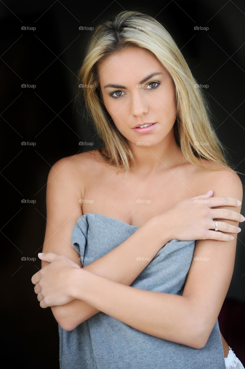 Portrait of a beautiful young woman on black background