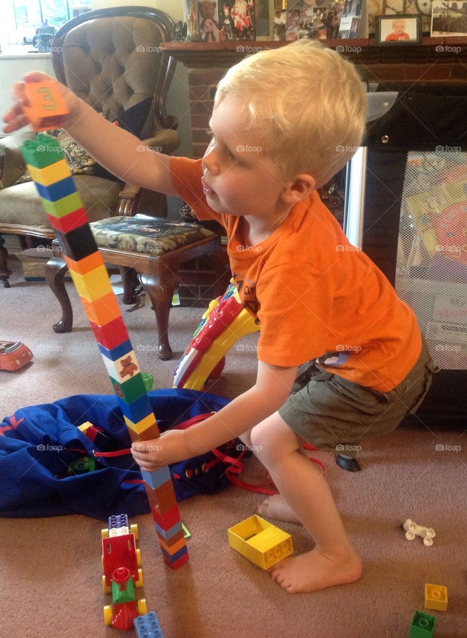 Concentration on building a Lego tower