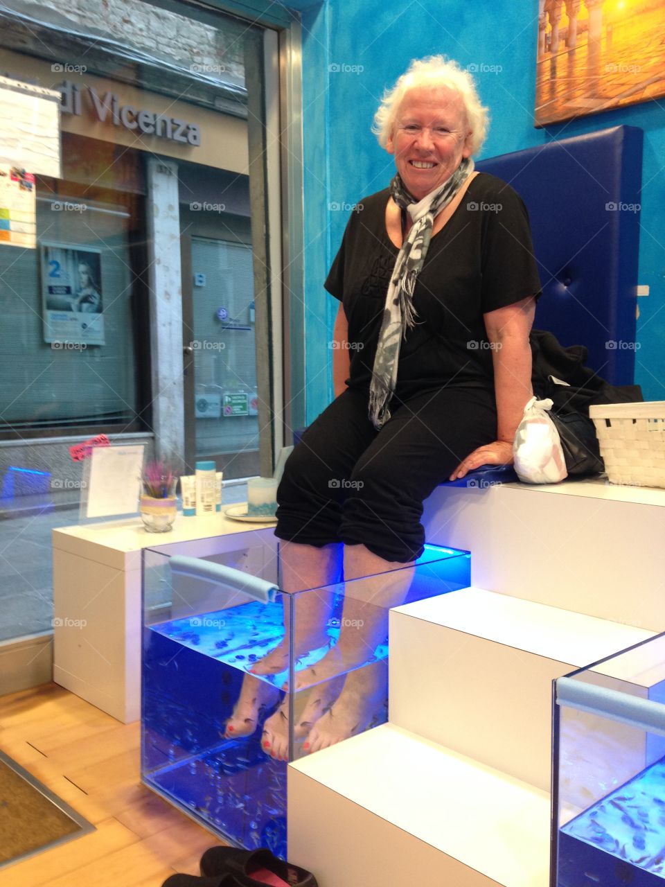 Woman taking fish pedicure treatment