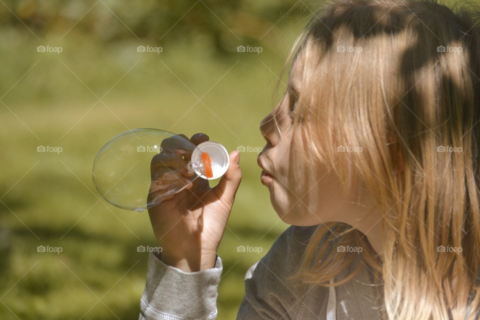 Girl blowing soapbubbles