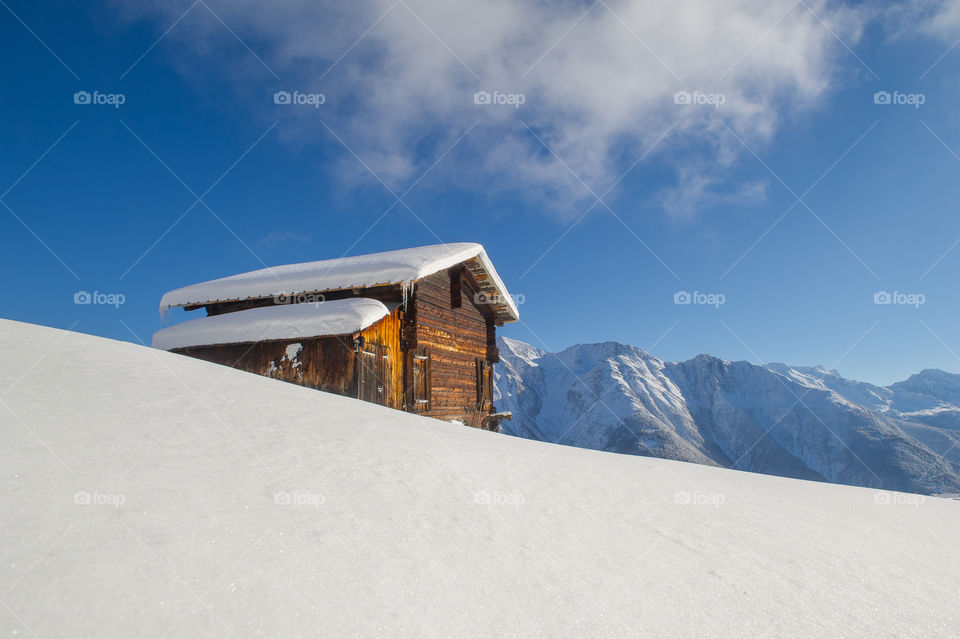 old wooden cottage in a winter landscape 