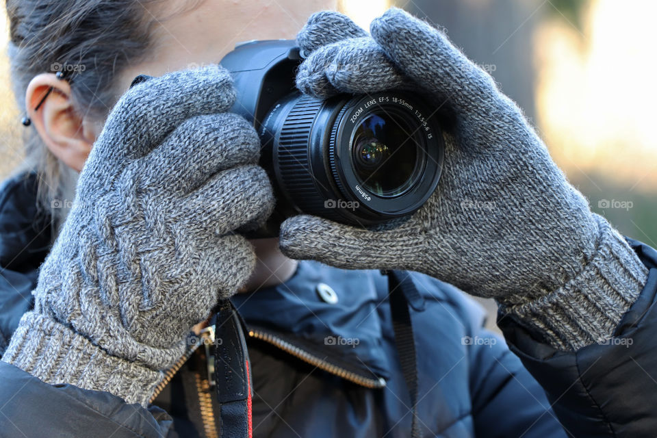 Young woman taking a photo with her camera