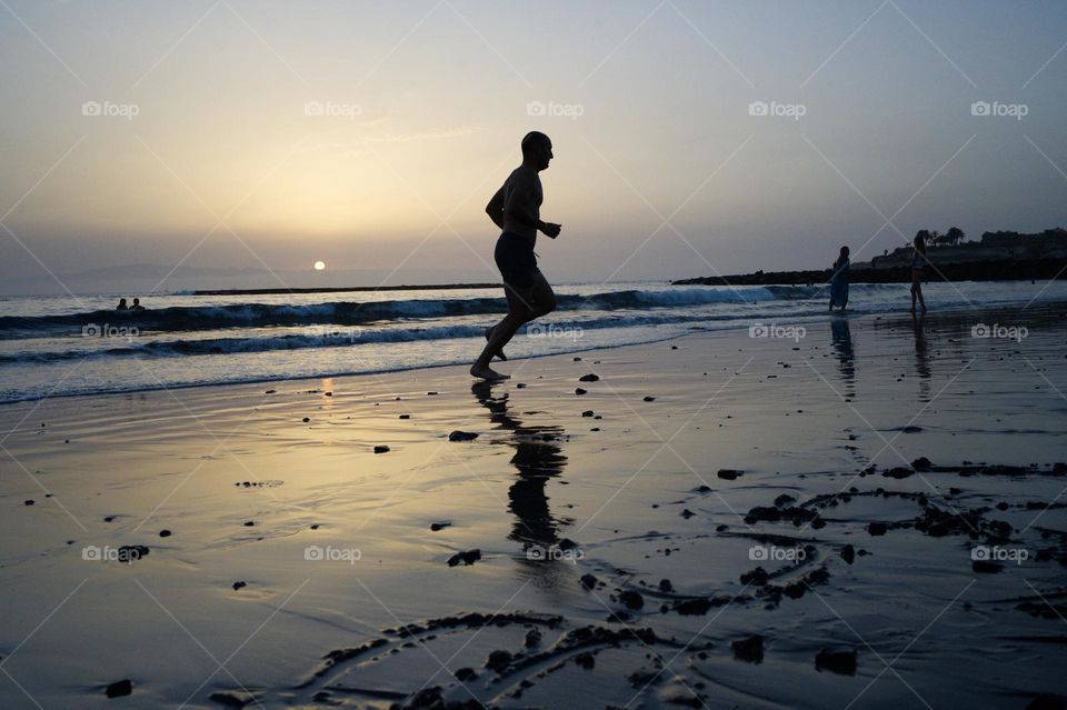 running by the sea at sunset