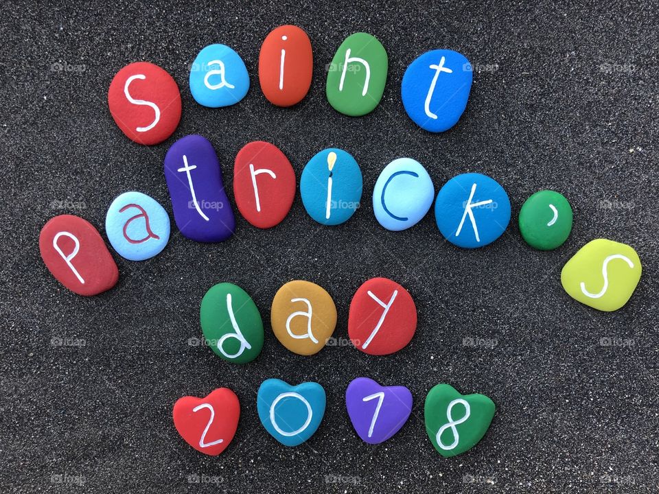 Saint Patrick’s day 2018 with colored stones over volcanic sand