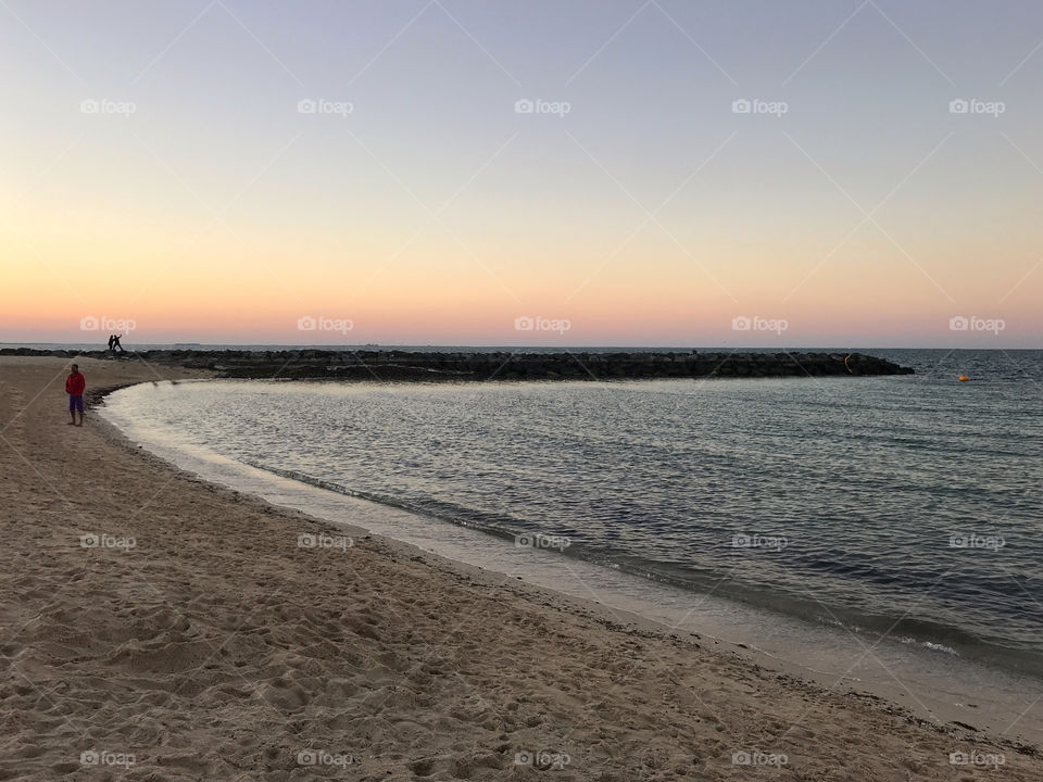 Alone on a deserted beach during sunset