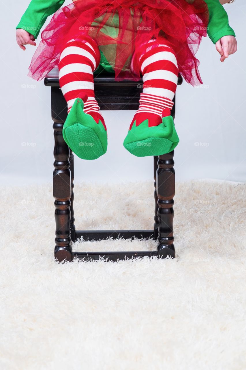 Child's legs with elf stockings and elf boots 