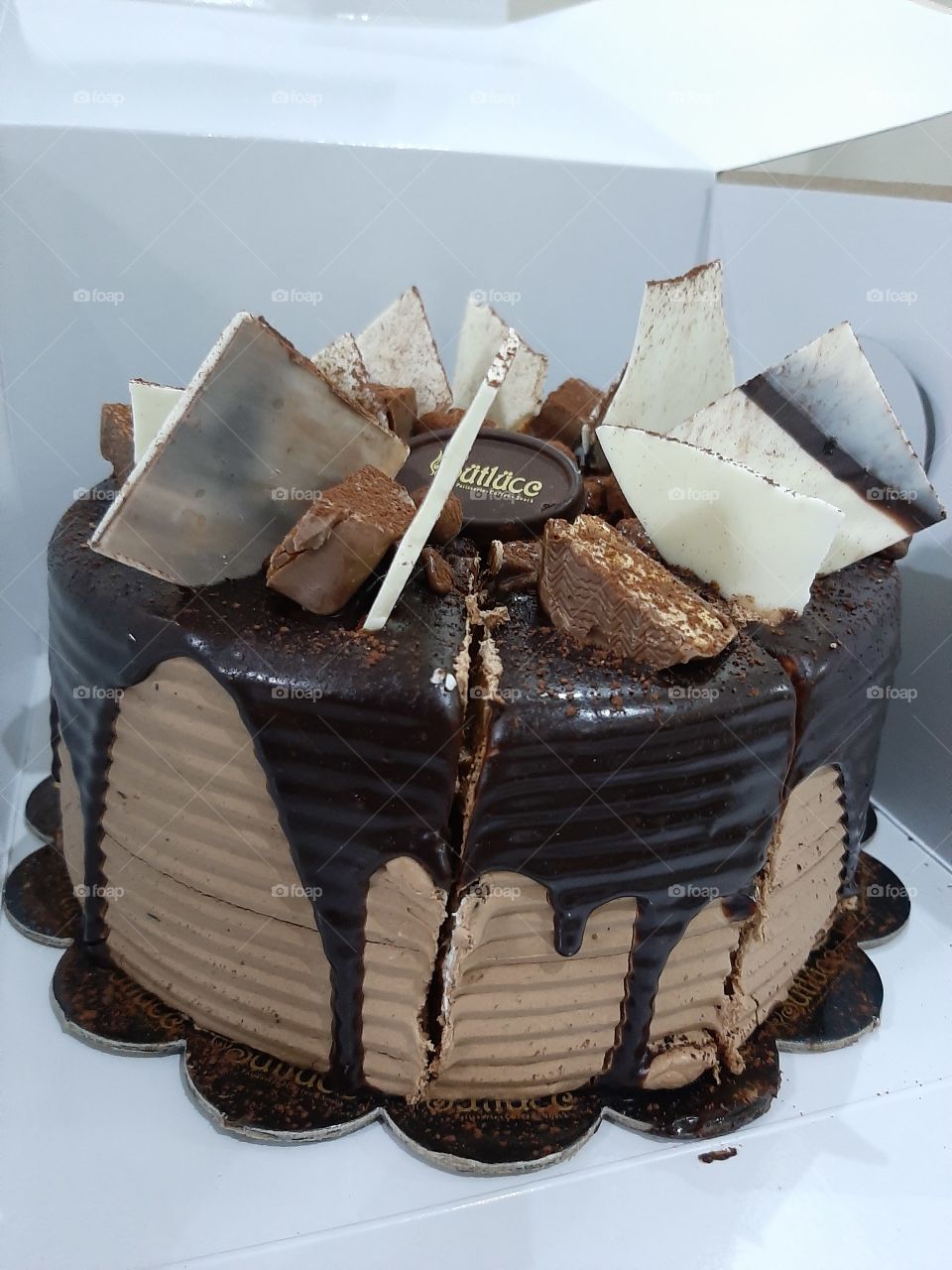 A choclate cake with sneackers pieces and milk and cacao choclate