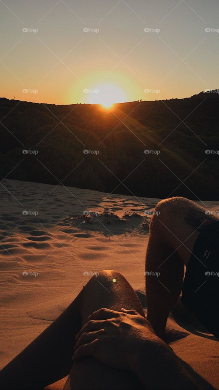 couple love at the beach with background sunset