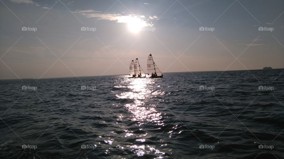 Darwin sunset. trio of boats at sea