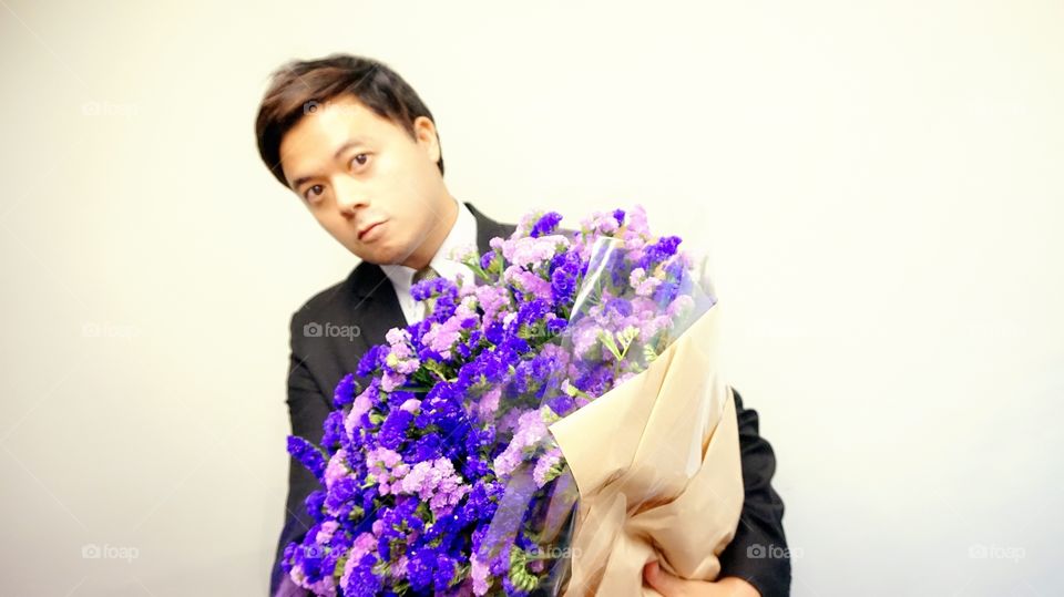 A guy with violet bouquet 