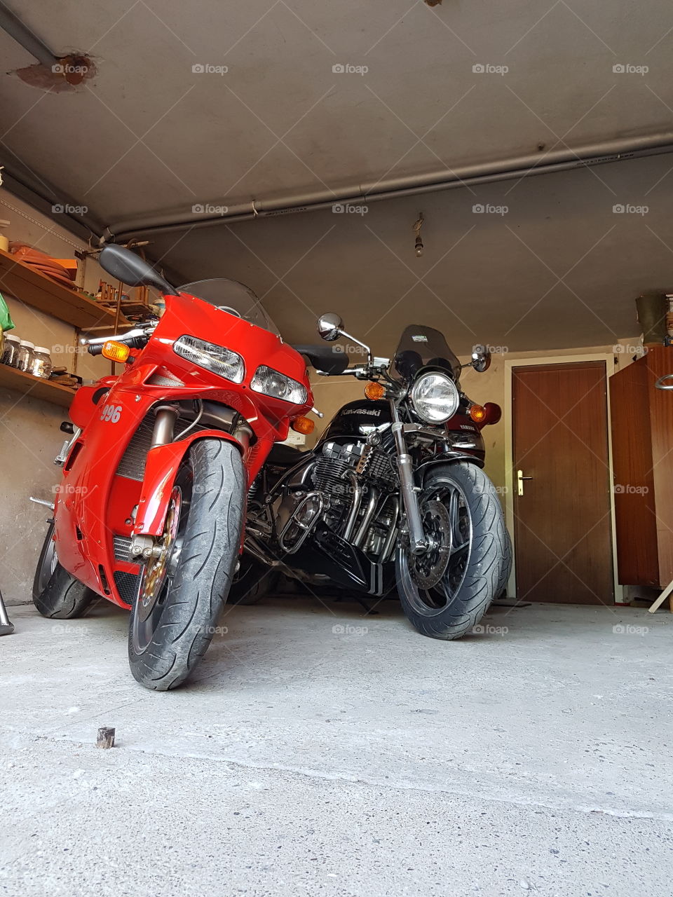 ducati 996s and Kawasaki Zephyr Z1 motorcycles in a garage