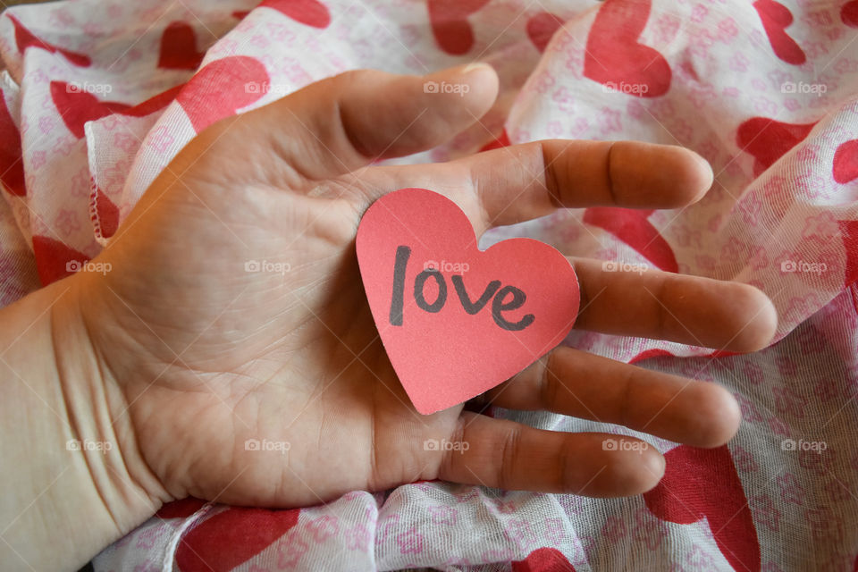 Hand holding heart shaped sentiment