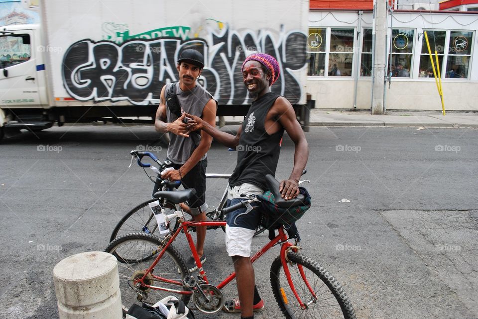 Two Friends Pose with their Bikes