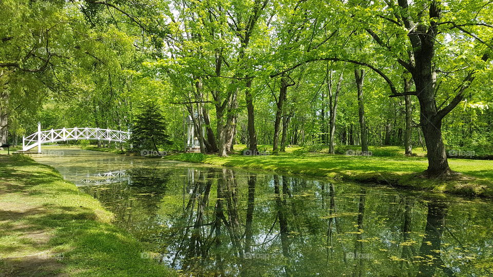 Along the pond crossed by a white bridge, Domaine des Maizerets, Quebec city, Québec, Canada.