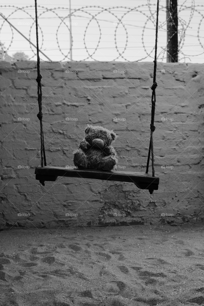 Sad bear on swing