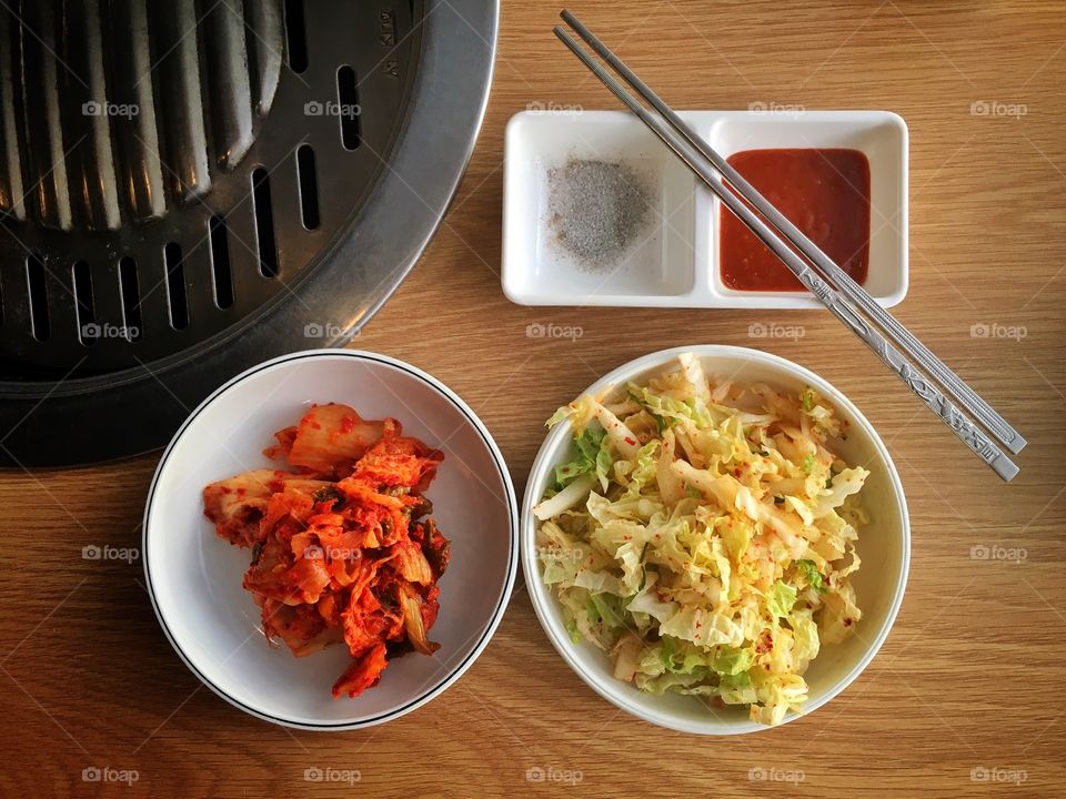 Korean side dish and metal chopsticks on a table