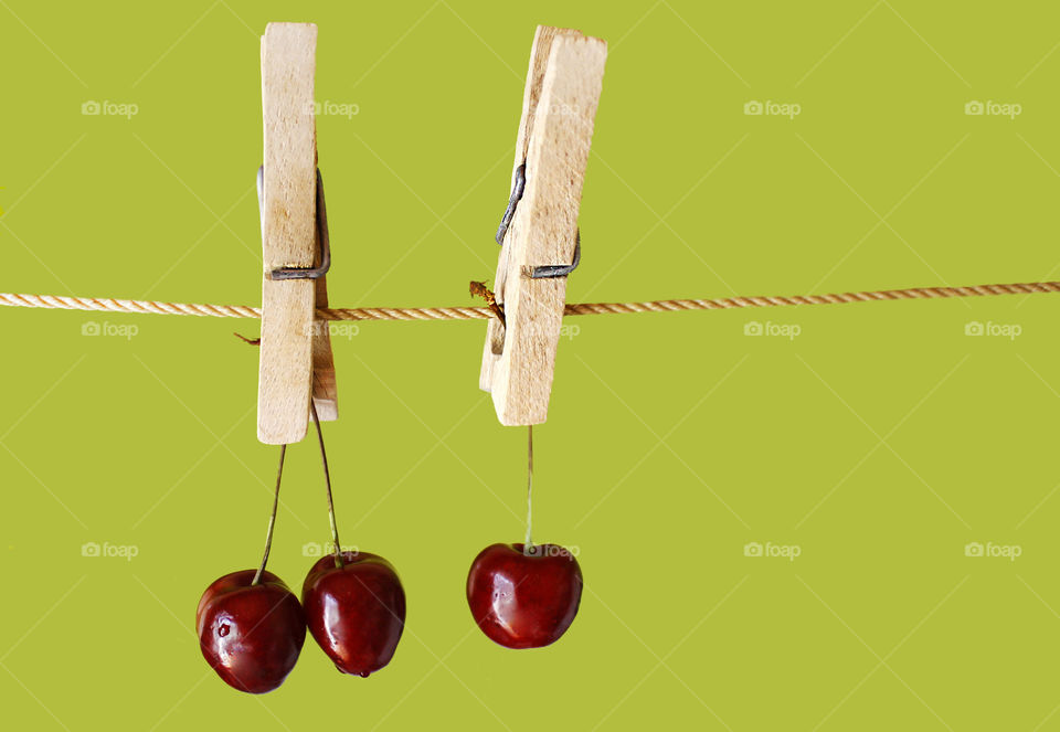 Cherries hanging on the rope