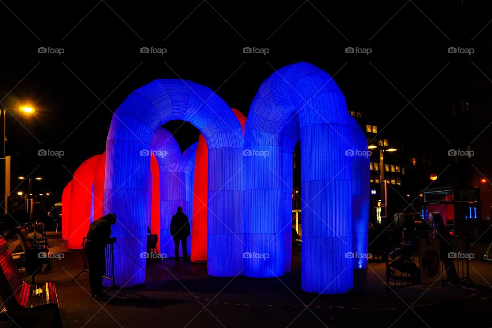 Beautiful view of the neon blue pipes labyrinth in the night city of Brussels, close-up side view. The concept of holiday attractions.