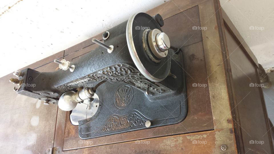 Vintage sewing machine. cast iron vintage. White brand sewing machine and cabinet