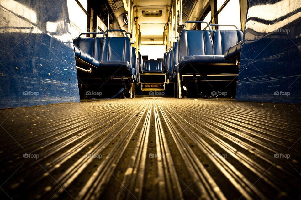 Interior shot of empty public transit bus. 