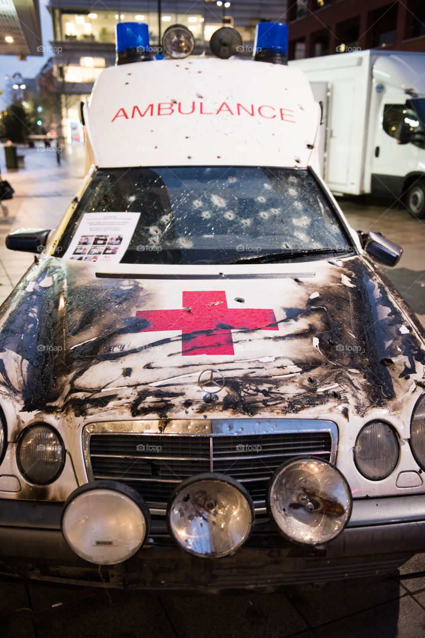 A real ambulance from the Red Cross who had been attacked in war. The Ambulance has bulletholes just everywhere and even firebombs have been thrown against it. The ambulance is part of efforts to make people aware of what happens in war. Ambulance shown up in various parts of the world. The picture is from Malmö Sweden.