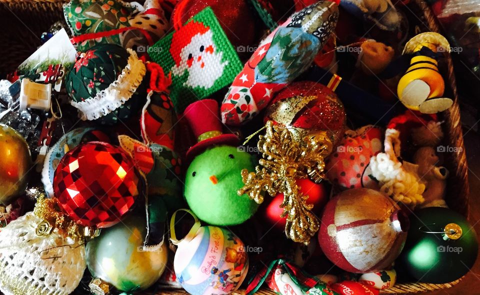 A lot of Christmas ornaments in a  wicker container.